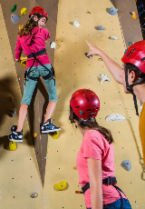 Three teens wearing red helmets