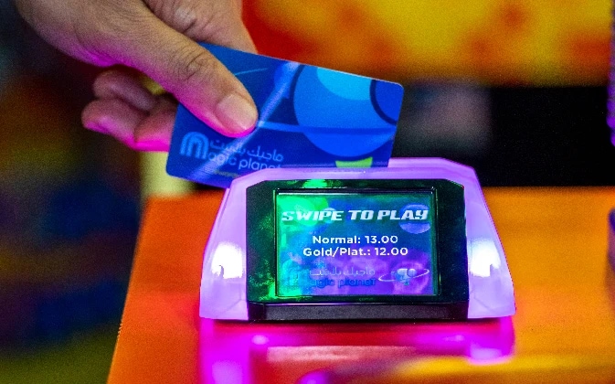 Swiping Magic Planet card in the machine